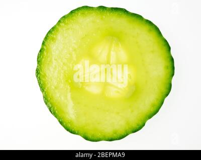 Single cucumber slice from above on a white background Stock Photo