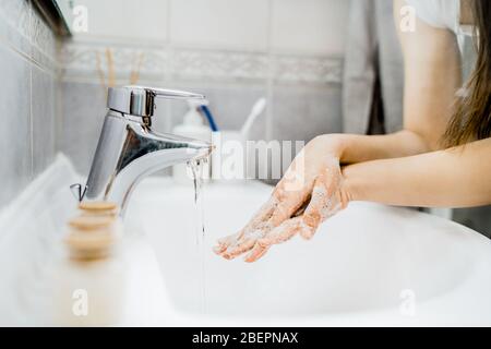 Antiseptic hand washing procedure with soap and water in the bathroom.Decontamination steps of hand hygiene routine.Cleaning hands, palms, interlaced finger Stock Photo