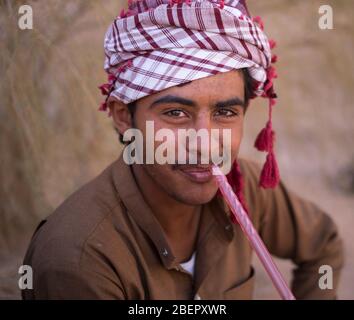 Portrait of a local Bedouin smoking a shisha pipe in Wadi Rum, Petra Stock Photo