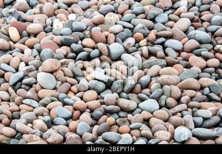Multi coloured pebbles on a beach Stock Photo