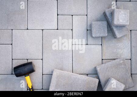 Paving stones paving background. Installing tools on foreground Stock Photo