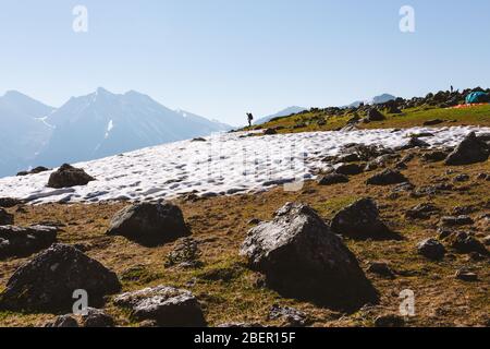 Man backpacker hiking in summit mountains. Hiking Traveling alone, healthy lifestyle active vacations trail running outdoor. Adventure traveling rocky Stock Photo
