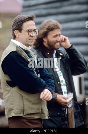 King Constantine II of Greece and Bee Gees singer Barry Gibb at a charity clay pigeon shoot, Chester, England 1985. Stock Photo