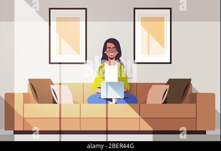 beautiful indian woman sitting on couch using laptop girl working from home freelance concept modern living room interior horizontal full length vector illustration Stock Vector