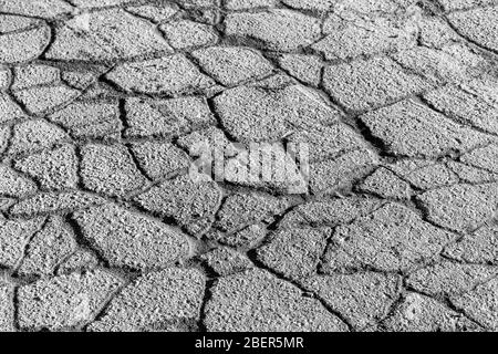 Texture of gray cracked asphalt. Abstract backdrop for design. Stock Photo
