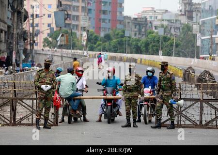 Dhaka, Bangladesh - April 015, 2020: Law enforcers urging people to stay at home in the capital’s Babu bazar Bridge neighbourhood on Saturday amid the Stock Photo