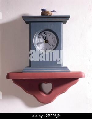 Modern cuckoo clock on wall shelf Stock Photo