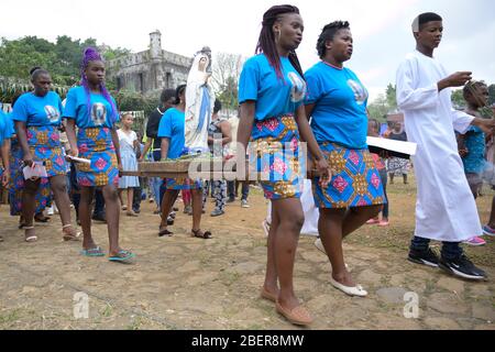 15 February 2020, São Tomé and Príncipe, Sundy: The inhabitants of the former plantation 'Roca Sundy' carry a statue of the Blessed Virgin Mary during a procession after an open-air service on the occasion of a festival in honour of Nossa Senhora de Lourdes. Photo: Sebastian Kahnert/dpa-Zentralbild/dpa Stock Photo