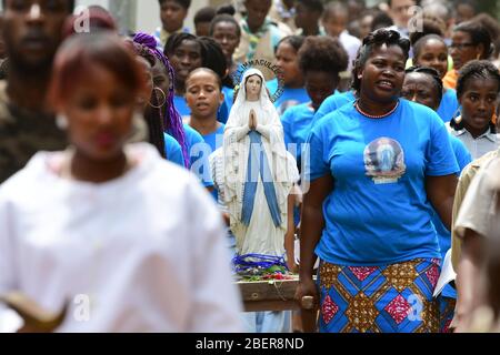 15 February 2020, São Tomé and Príncipe, Sundy: The inhabitants of the former plantation 'Roca Sundy' carry a statue of the Blessed Virgin Mary during a procession after an open-air service on the occasion of a festival in honour of Nossa Senhora de Lourdes. Photo: Sebastian Kahnert/dpa-Zentralbild/dpa Stock Photo