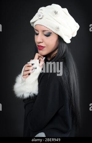 Winter portrait of a young romantics woman in a white hat and gloves Stock Photo