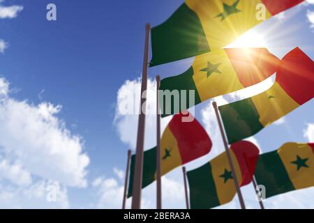 Senegal waving flag against blue sky Stock Photo - Alamy