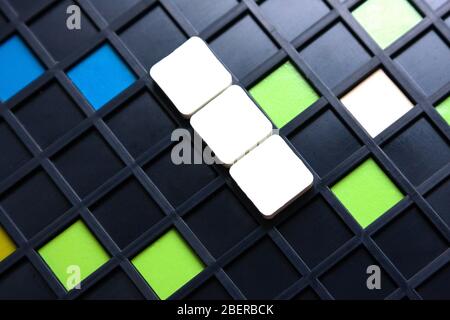 Empty blank scrabble pieces on game board Stock Photo