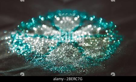 abstract form background composed of silver and blue bokeh on black background Stock Photo