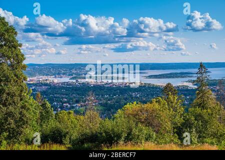 Oslo, Ostlandet / Norway - 2019/09/02: Panoramic view of metropolitan Oslo and Oslofjorden sea bays and harbors seen from the Holmenkollen hill Stock Photo