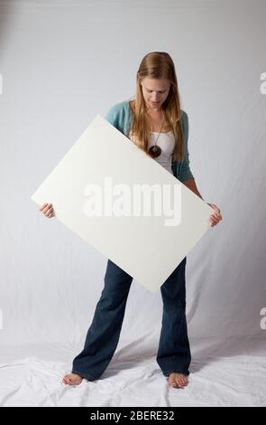 Pretty Blond holdinga blank sign for your message Stock Photo - Alamy