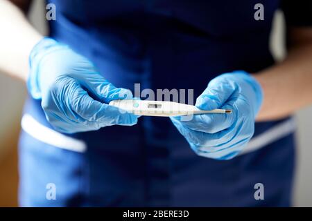 Nurse holding thermometer Stock Photo