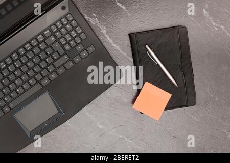 home office concept with blank post it note and laptop computer. Stock Photo