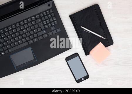 home office concept with blank post it note and blank phone screen Stock Photo