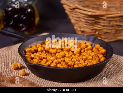 Spicy roasted chickpeas in a black metal pan. Healthy and vegetarian food Stock Photo