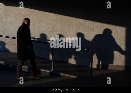 Istanbul, Turkey - March 12, 2011 : Walking man and shadows of people on the wall at Istanbul Stock Photo