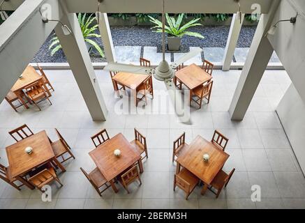 Aerial view of tables and chair in empty cafe of the hotel. Loft interior concept. Stock Photo