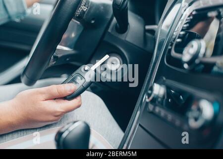 Woman driver starting the car by car key, transport concept Stock Photo