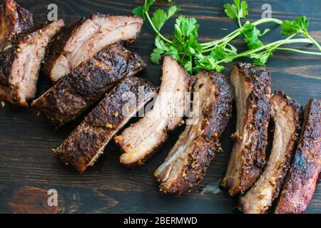 Jamaican Jerk Pork Ribs:Spicy barbecued baby back ribs on a wood cutting board Stock Photo