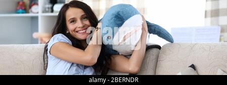 Woman holding toy shark Stock Photo