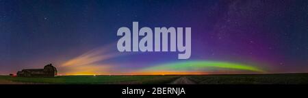 Panorama of aurora and solstice twilight at an old barn in Alberta, Canada. Stock Photo