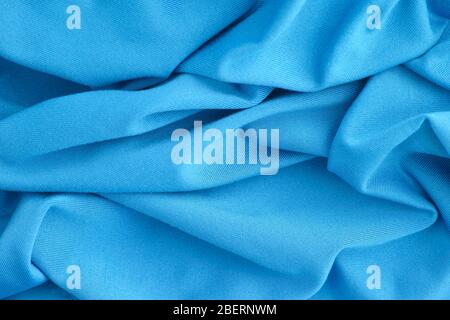 Blue wrinkled fabric texture background. Close up. Stock Photo