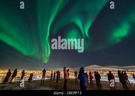 People aboard MS Trollfjord observing the auroral swirls over Batsfjord, Norway. Stock Photo