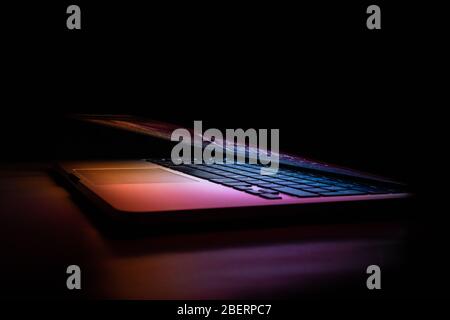 a macbook with purple light Stock Photo