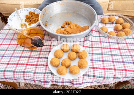 Traditional Turkish Food; Stuffed Meatballs,  Turkish known as 'icli kofte'. Woman making Stuffed Meatballs at home. Stock Photo