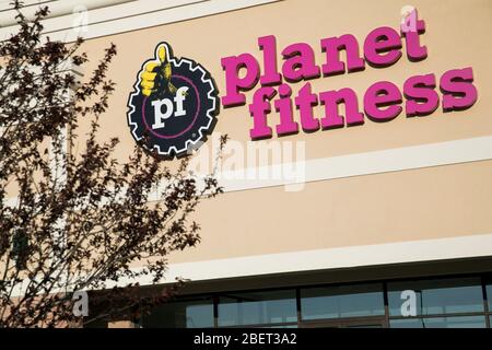 A logo sign outside of a Planet Fitness location in Newark, Delaware on April 11, 2020. Stock Photo