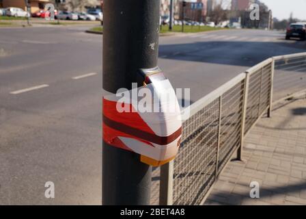 Coronavirus pandemic. Light switch at pedestrian crossing protected against touching. Stock Photo