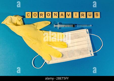 A medical mask, medical gloves on the blue surface. Concept coronavirus, flu, infection, epidemic. View from above. horizontal orientation. View from Stock Photo