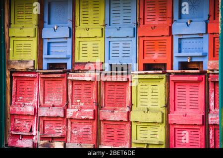front of colorful old bee hives in Germany Stock Photo