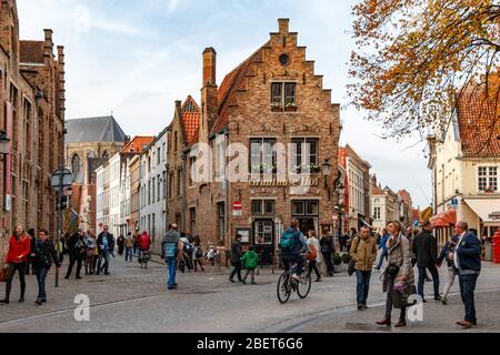 People walking by the Gruuthuse Hofe in Bruges / Brugge in autumn Stock Photo