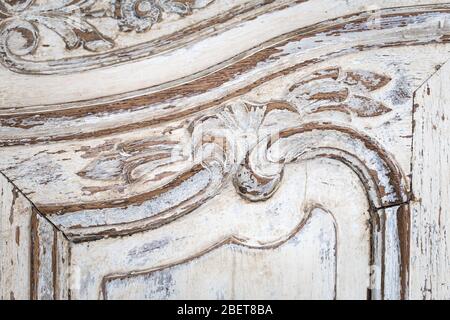 Old wooden antique chest of drawers with metal handles closeup. Stock Photo