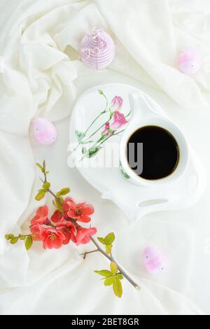 Decorated Easter eggs , a porcelain mug and plate and a blossom branch Stock Photo
