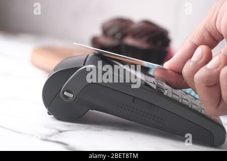 Payment terminal charging from a credit card , close up Stock Photo