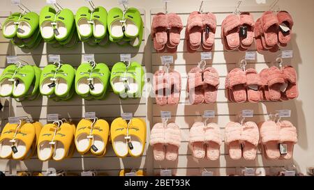 Moscow, russia, April 2, 2020 - Many pairs of bedroom slippers shoes for sell in the shopping mall.fabric colorful slippers in clothes shop. Shopping Stock Photo