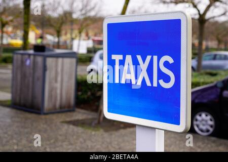 taxi blue sign service signage hanging on pole street Stock Photo