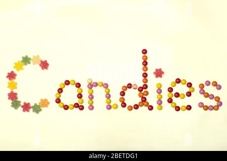 A word Candies lined with colorful candies on a light background Stock Photo
