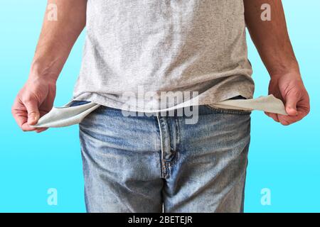 Inverted empty pockets. The young man turned out empty jeans pockets.  Stock Photo