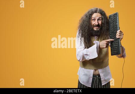 Weird, funny nerd posing wit a black pc keyboard Stock Photo