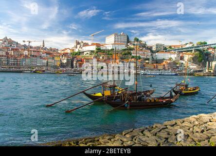 Portugal, city landscape Porto, wooden boats with wine port barrels close up on Douro, panoramic view of the old town Porto, Porto in summer, colored Stock Photo