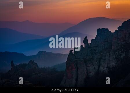 Beautiful sunset painting the sky over the oddly shaped sandstone rocks in the epic town of  Belogradchik, northwest Bulgaria Stock Photo