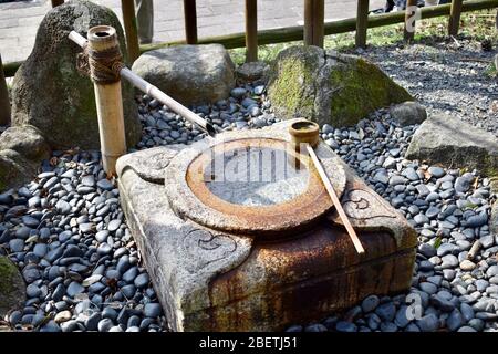 Temizuja - water tank for ritual of washing the hands and mouth, Sagi-Ike pond area, Nara, Japan Stock Photo