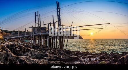 Sunset on Trabucco da Mimì, located along the coast of Puglia, Italy. Stock Photo